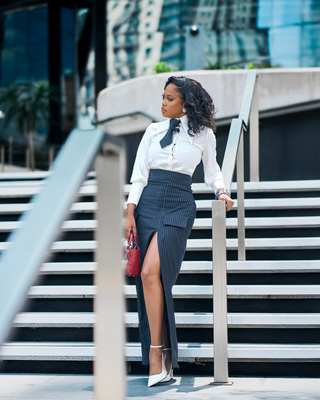 Ratile Mabitsela iconic look, white blouse and pinstripe skirt